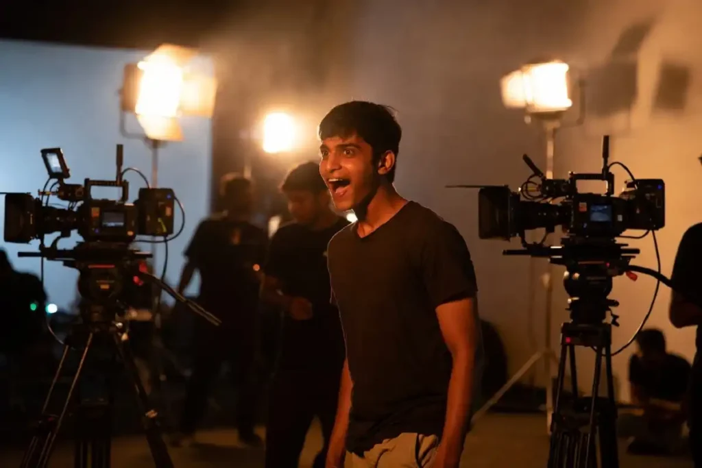 Scene from Ashakal Aayiram showing the cinema world backdrop and aspiring actor storyline