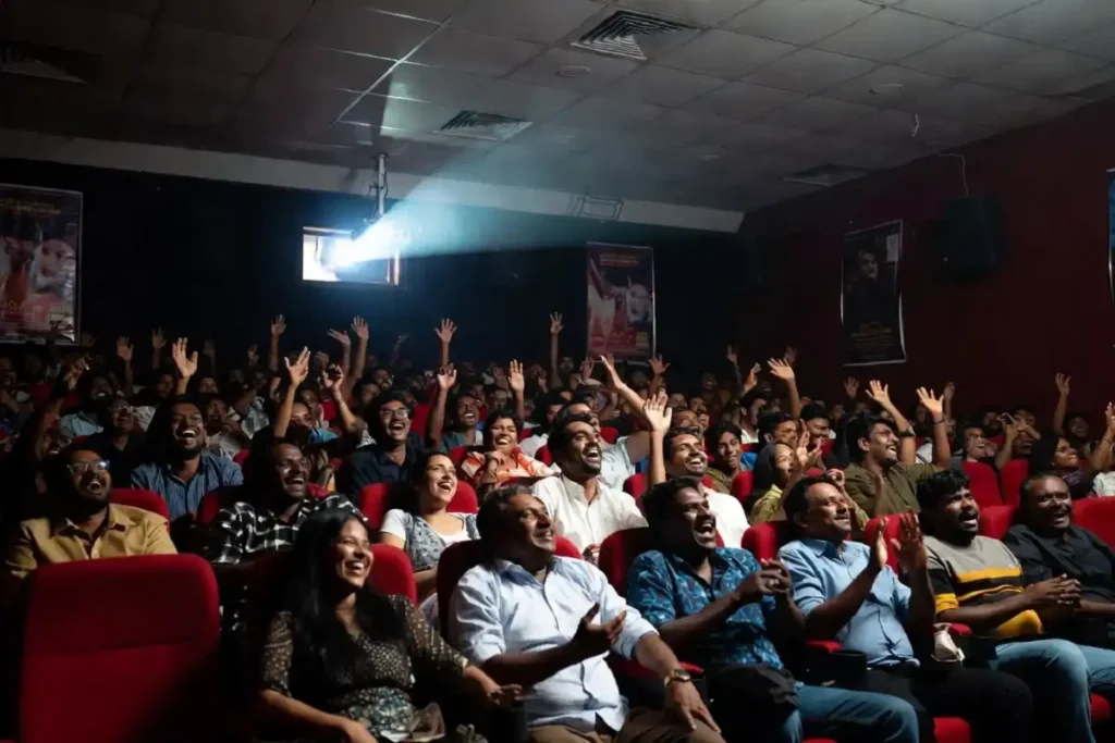 Audience watching a Malayalam film in a Kerala cinema